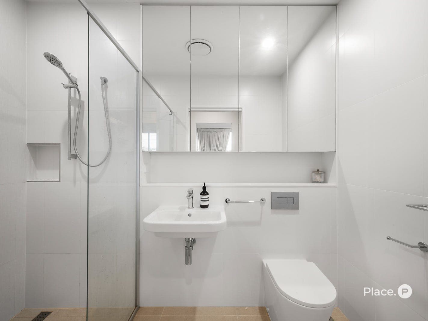 Master ensuite — frameless shower, mirrored cabinetry and floating vanity