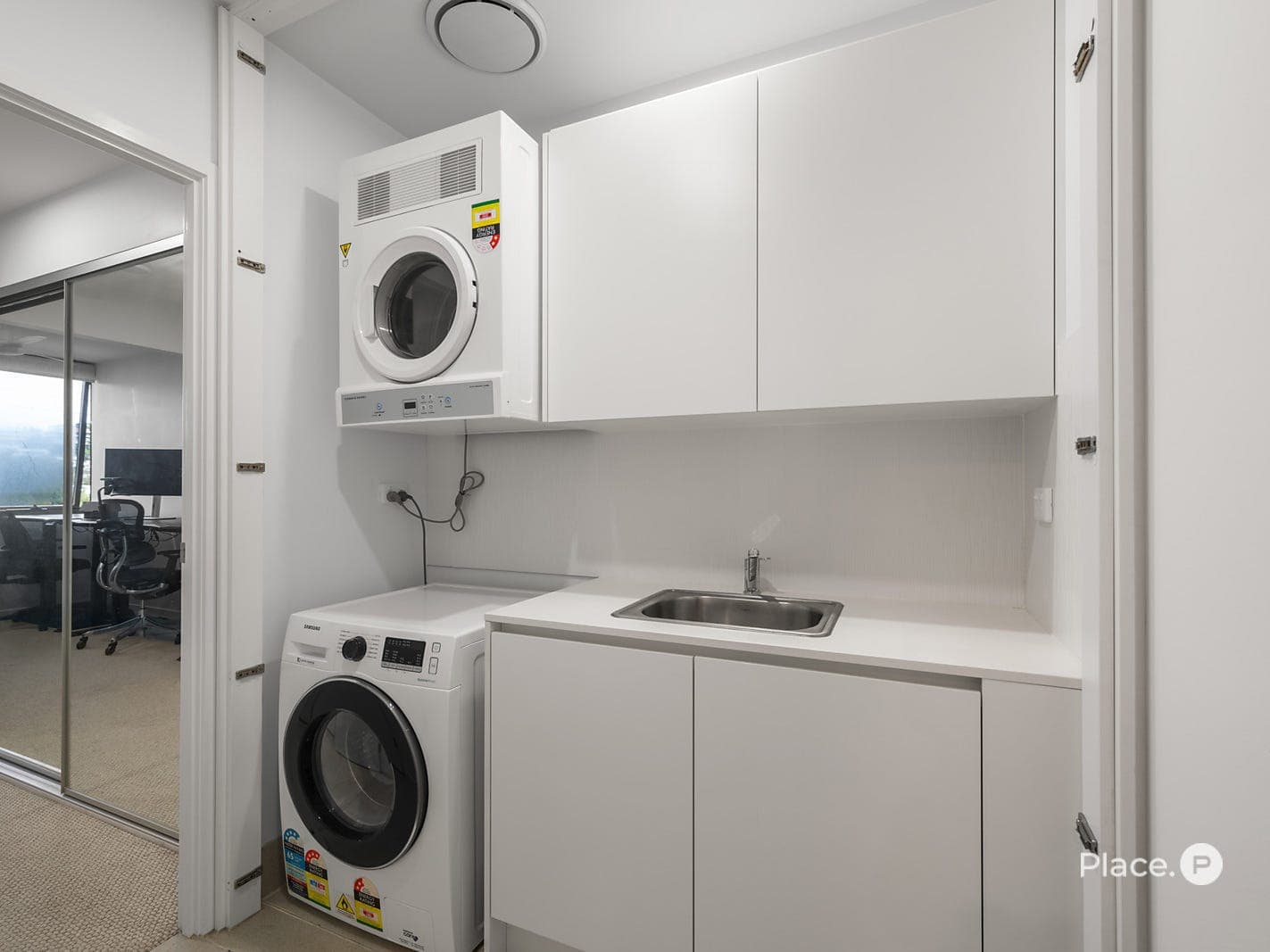 Separate internal laundry with sink and built-in cabinetry