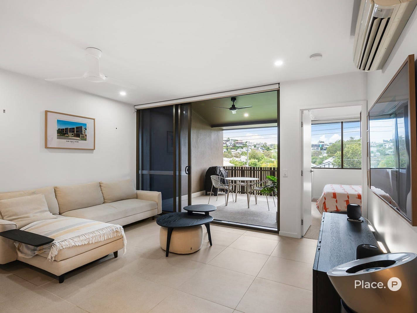 Lounge area with sliding doors to the balcony and master bedroom beyond